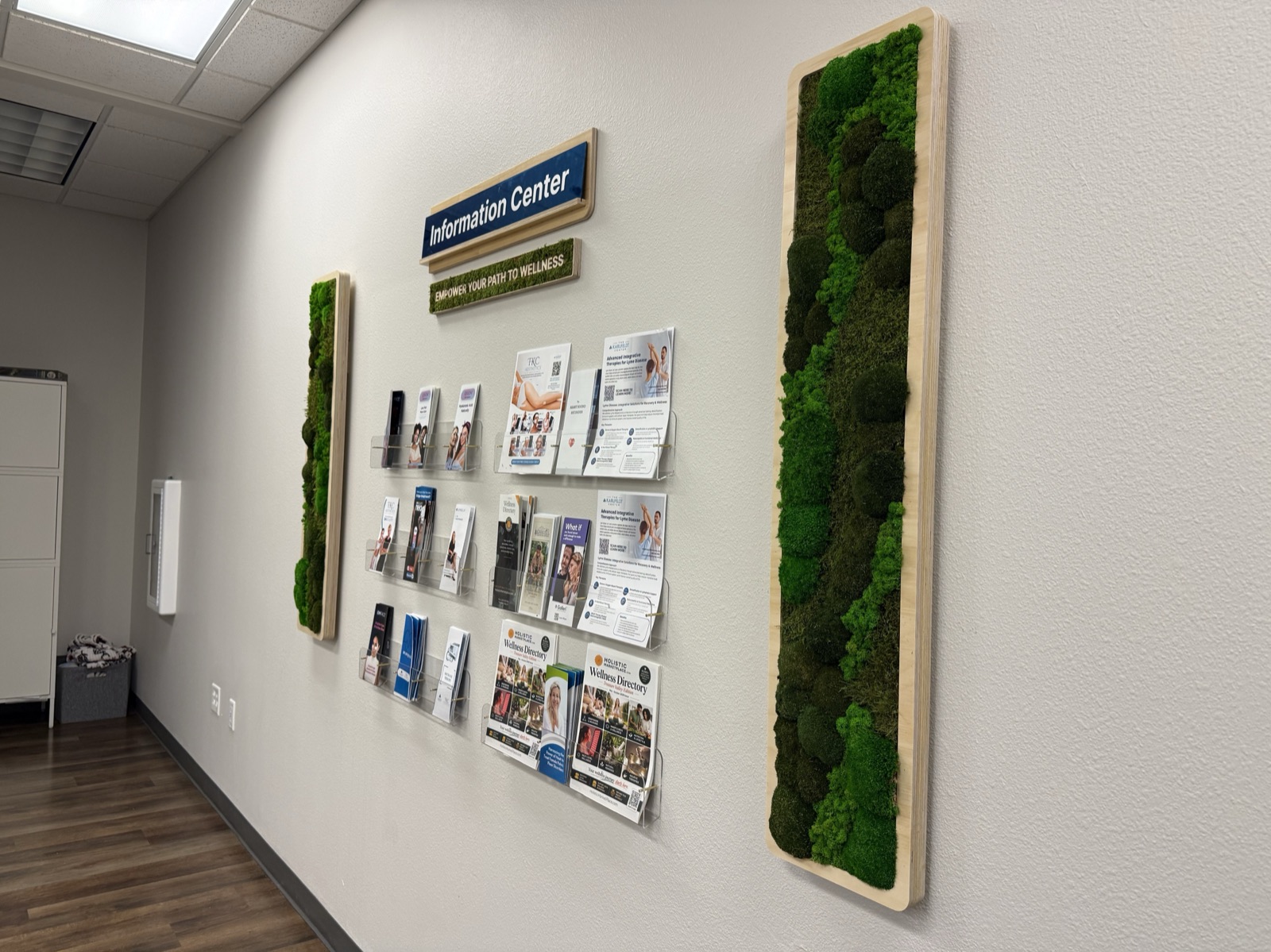 Tall moss accent panels flanking the Karlfeldt Center information wall