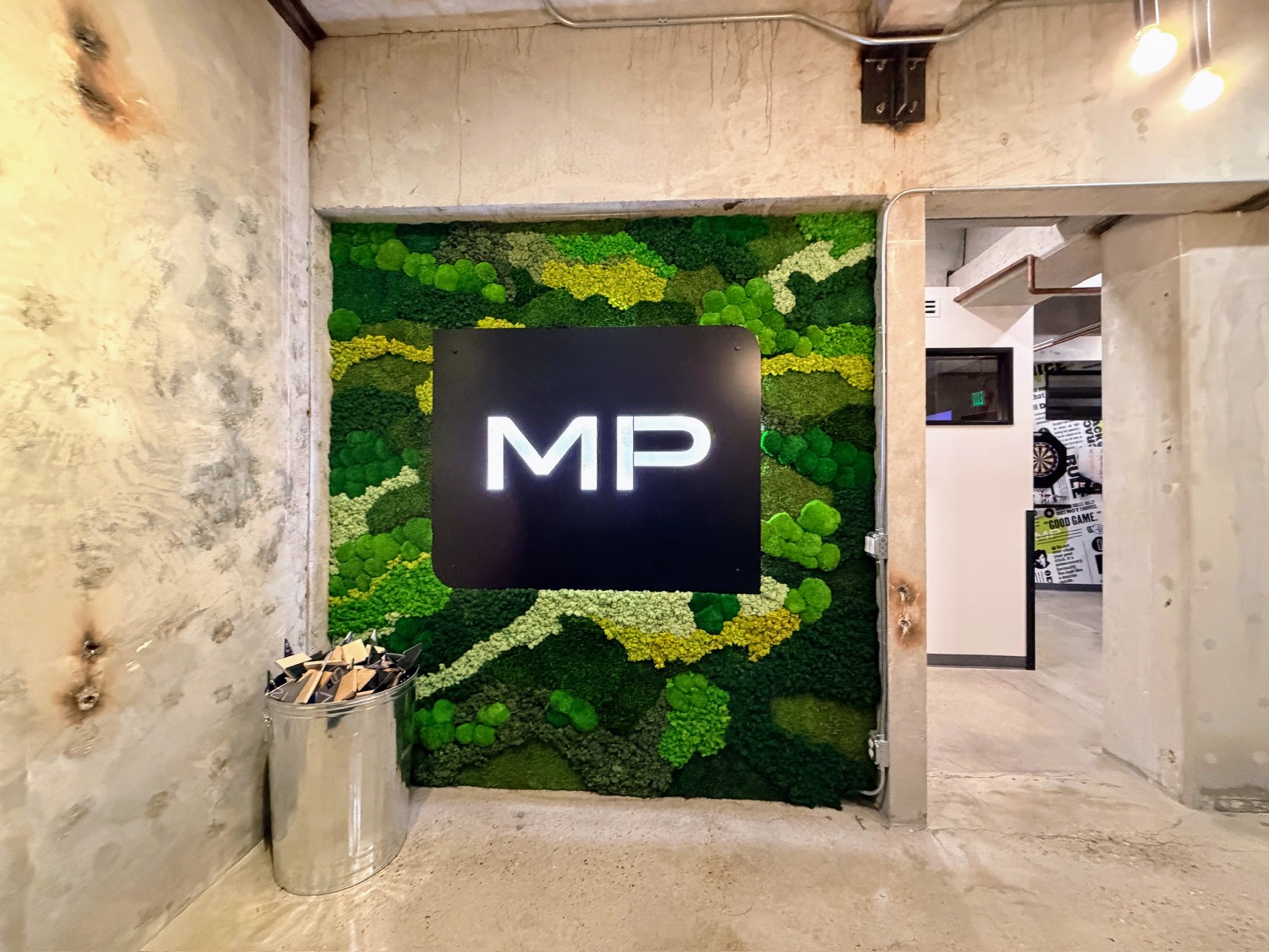 The Mitchell + Palmer entry with the moss wall beside the studio doorway